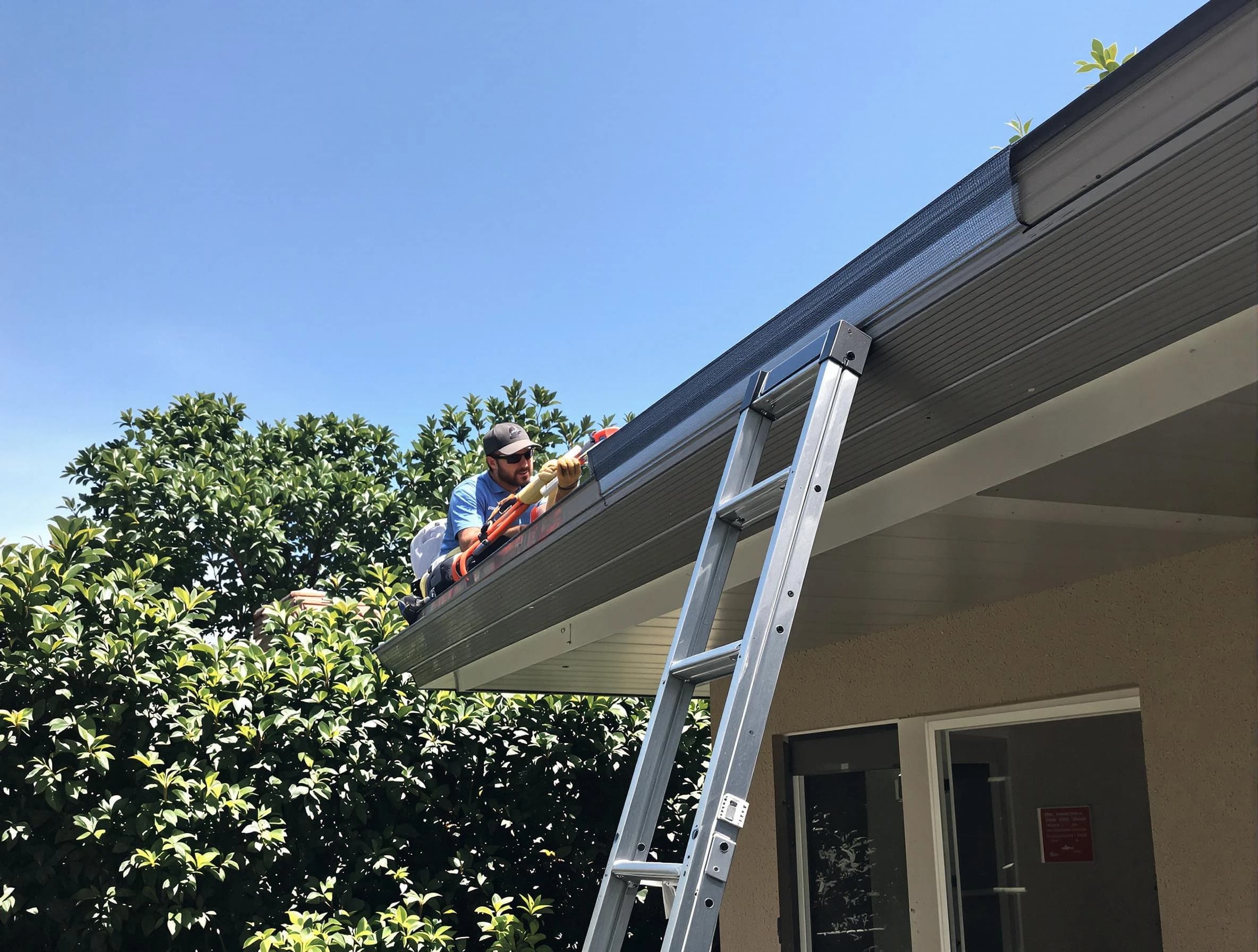 Lakewood Roofing Company installing gutter guards for a homeowner in Lakewood, OH